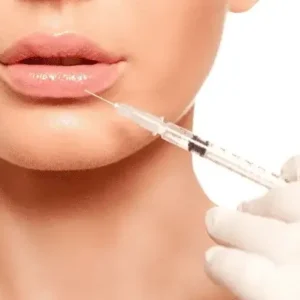 Woman receiving lip filler treatment for hydration and volume.